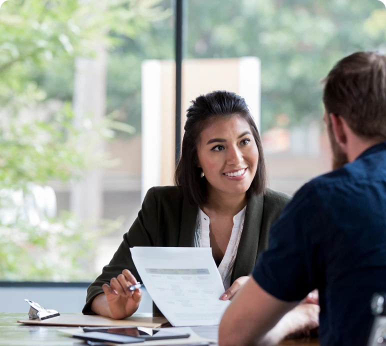 Woman discussing documents with a colleague