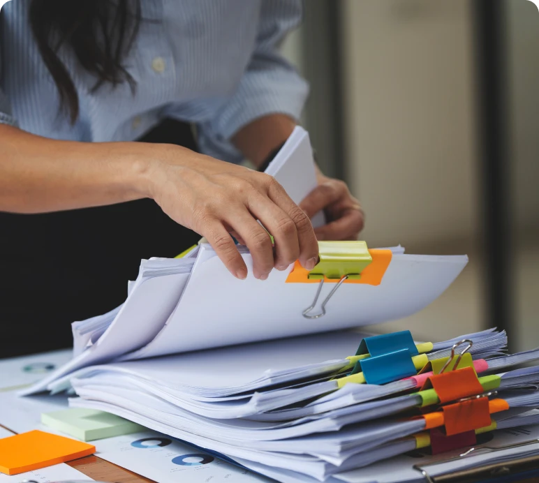 Hands arranging files with sticky notes
